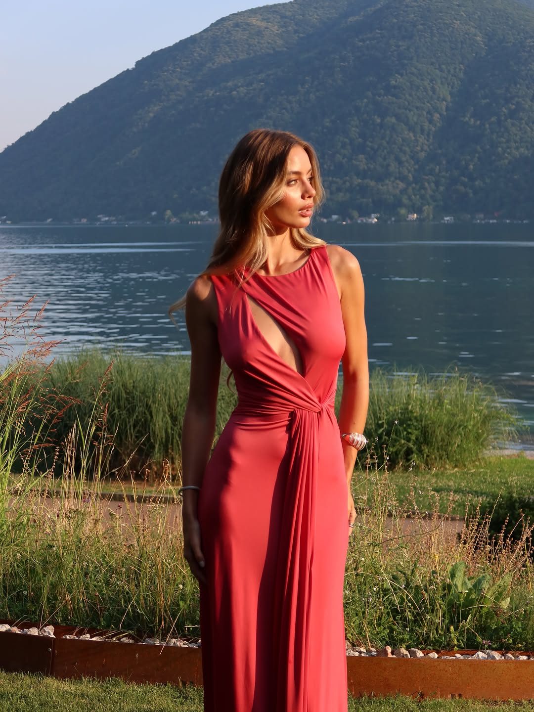 Garance, coral gown by the lake, July 2026